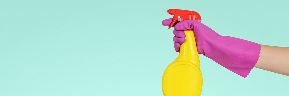 cleaning with gloves and spray bottle